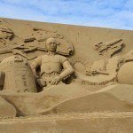 A portrait of R2D2 & C3PO in sand